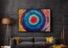 MOVEMENTS original circular abstract acrylic painting by Daniel Mikaelian displayed in a modern living room.